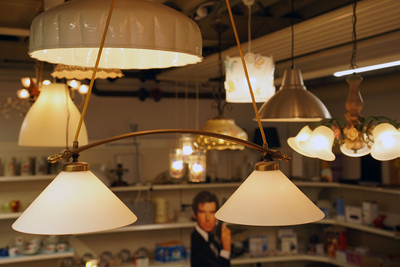 Auf dem Bild sind verschiedene Lampen und Leuchten in einem Geschäft oder einer Ausstellung zu sehen.